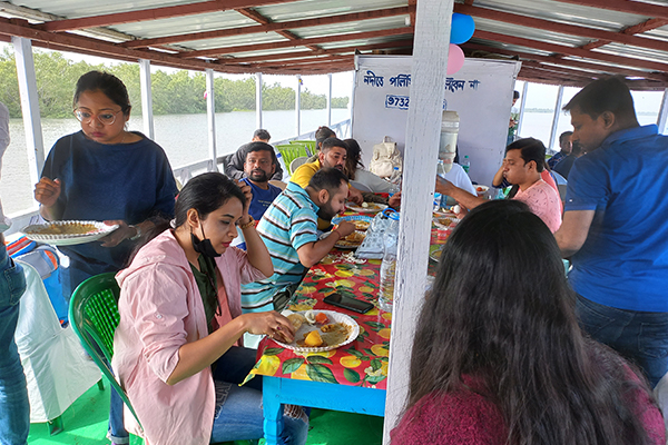 Group dining on Sundarban tour boat